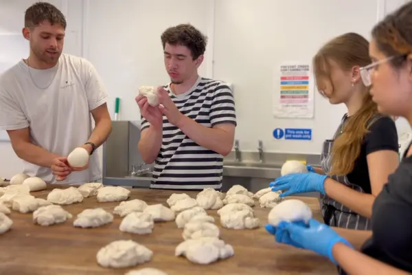 young people making pizza dough at the dusty knuckle as part of eat club's hospitality kickstart programme